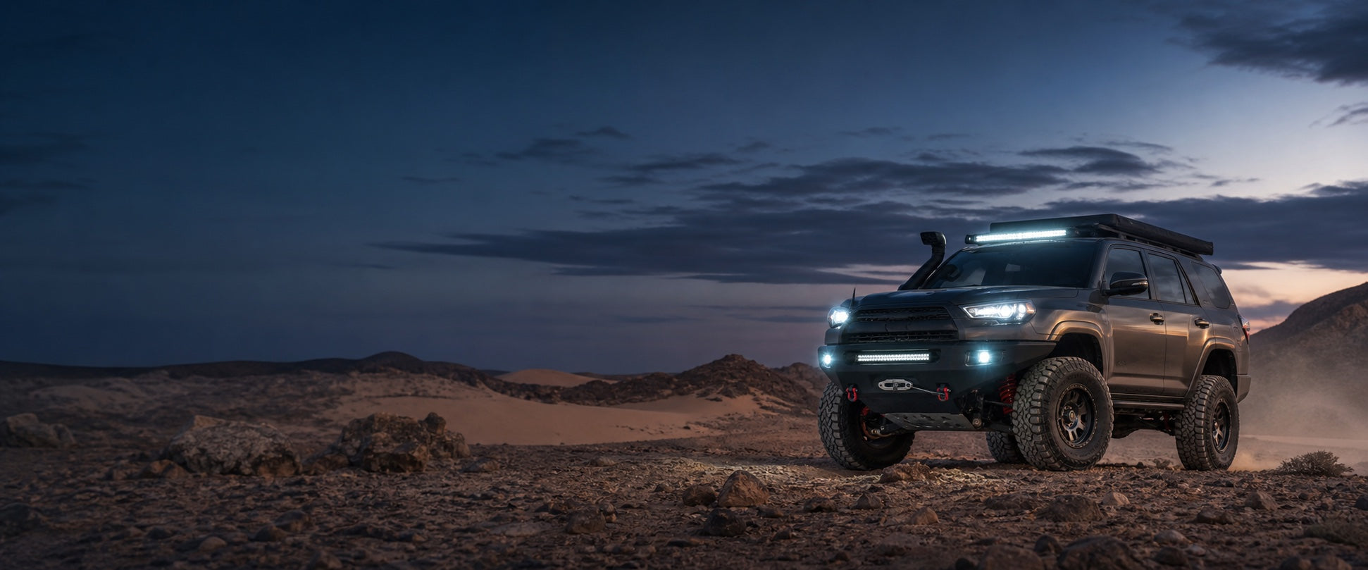 Performance four-wheel-drive vehicle in the Qatar desert at blue hour