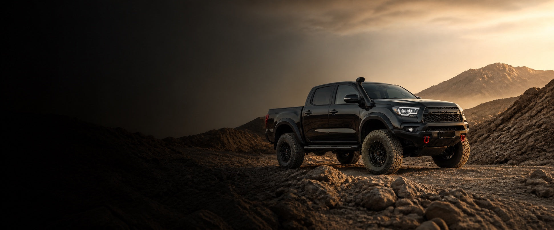 Black off-road pickup truck on a rugged Qatar desert trail